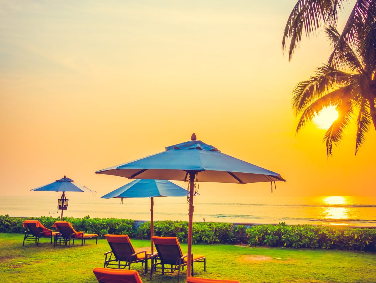 Empty umbrella and chair on the beach at Twilight Times - Vintage Filter